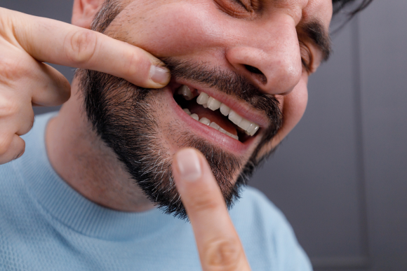 Patient with a confident smile after tooth replacement at Keene Family Dentistry