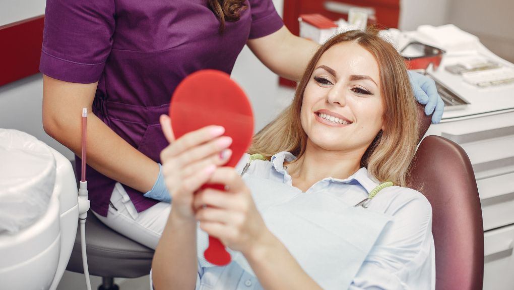 Patient admiring her new same-day dental crown at Keene Family Dentistry