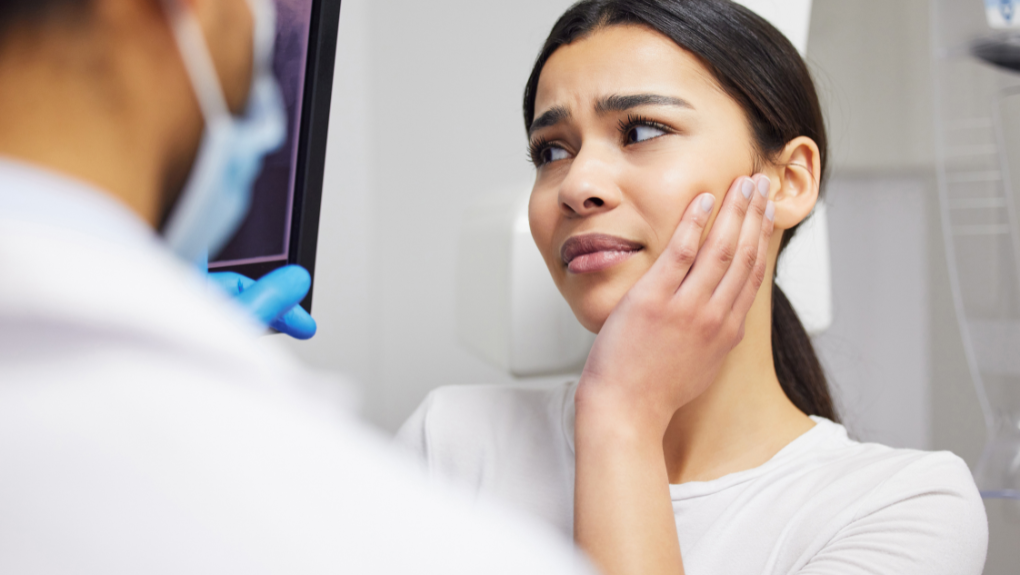 Patient being evaluated for a dental emergency near Burleson, TX