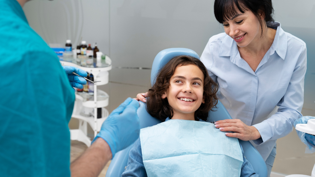 Child smiling with the dentist at Keene Family Dentistry near Alvarado, TX