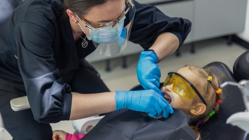 Dentist performing a gentle pediatric exam at Keene Family Dentistry